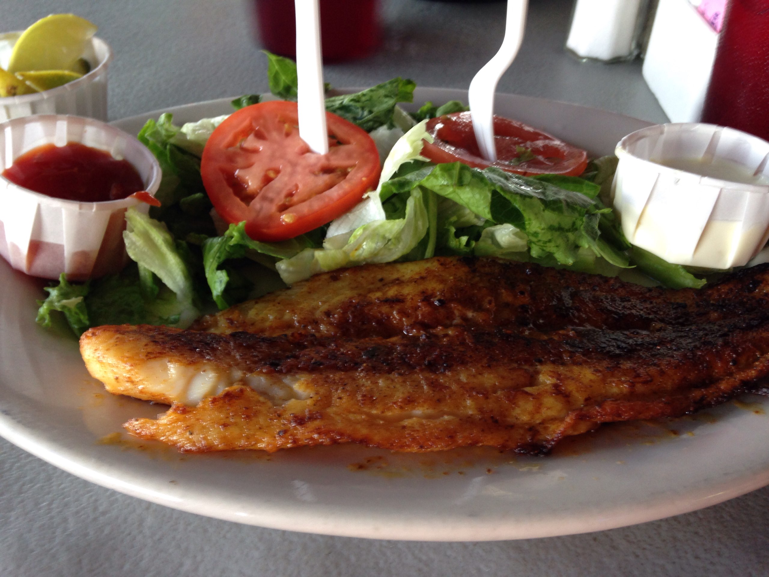 Blackened fish with a special Cajun seasoning and a side salad (without