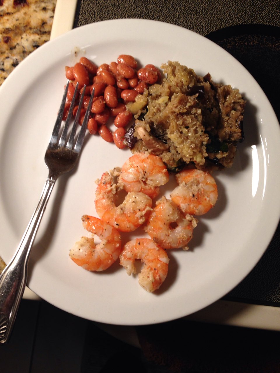 Dinner tonight . Shrimp , kidney beans, quinoa mixed with eggplant