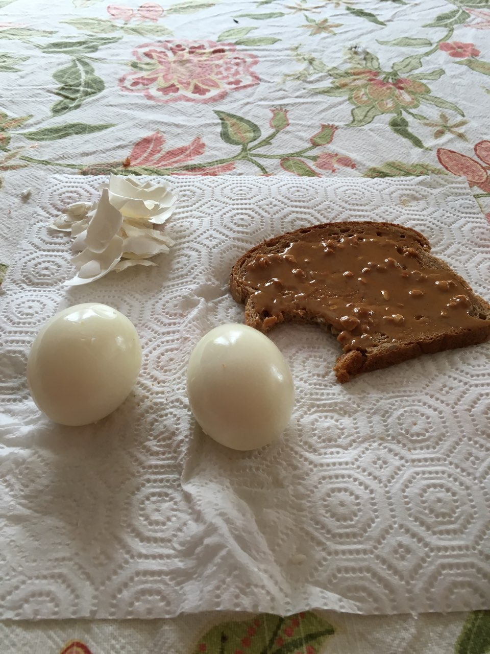 2 hard boiled eggs with a piece of toast with organic peanut butter for