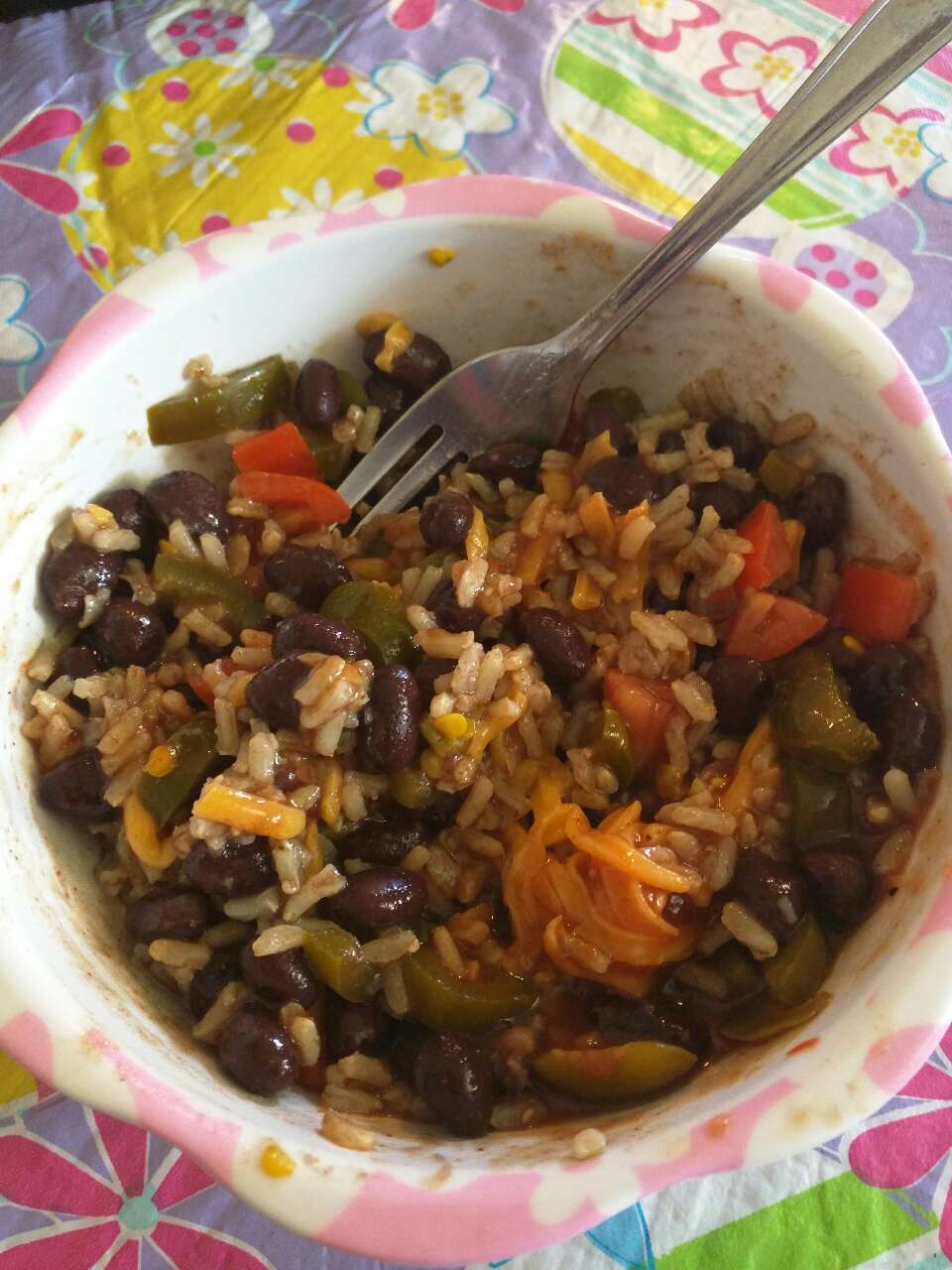 Lunch black beans and brown rice with fresh tomatoes, cheddar cheese