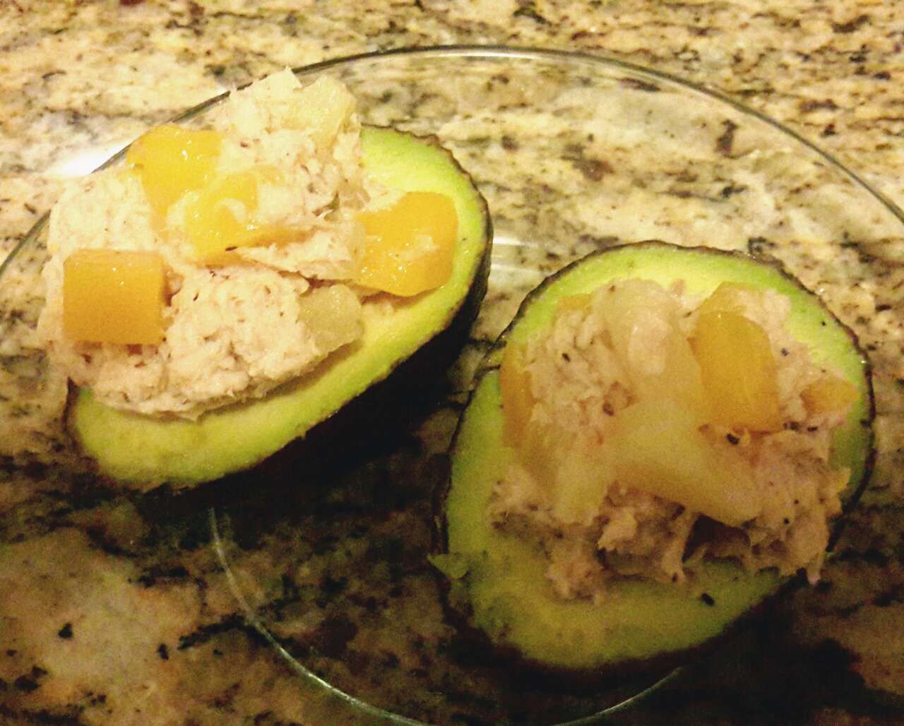 My tropical tuna topped on avocado halves. Tuna was prepared with freshly squeezed lemon juice