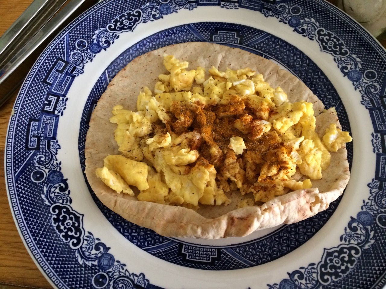 My late breakfast scrambled eggs on whole wheat pita bread. (I put a