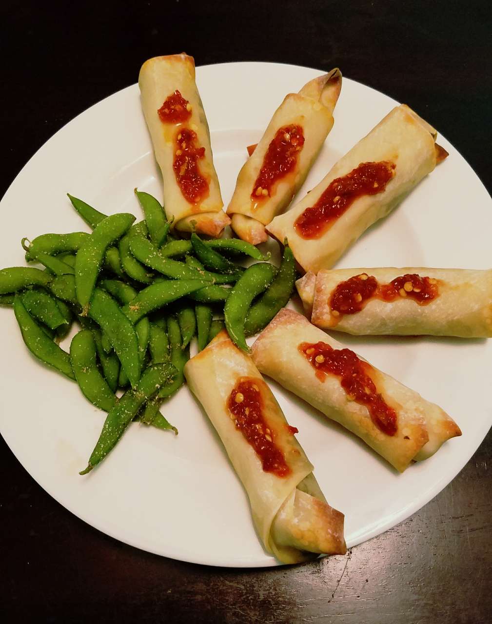 teriyaki tofu and black bean baked spring rolls with garlic chili paste