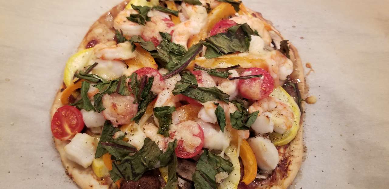 Shrimp and scallop pizzayello zucchini, orange peppers, mini bellas