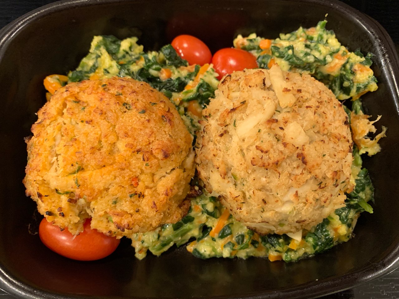 Crab cakes and creamy polenta with spinach and carrots. That’s for