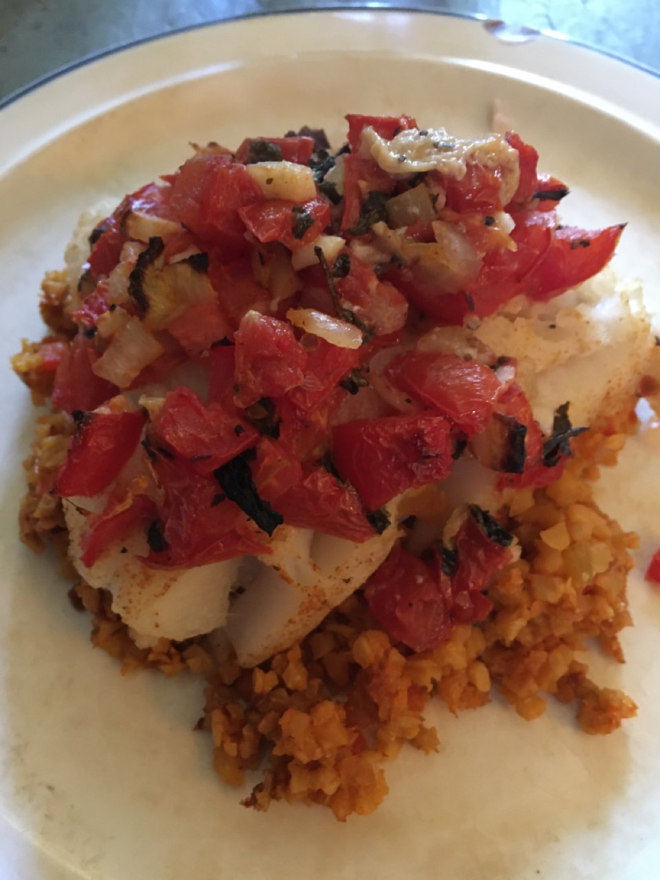 Roma tomato mixed with basil, garlic and onion on top of Spanish ...