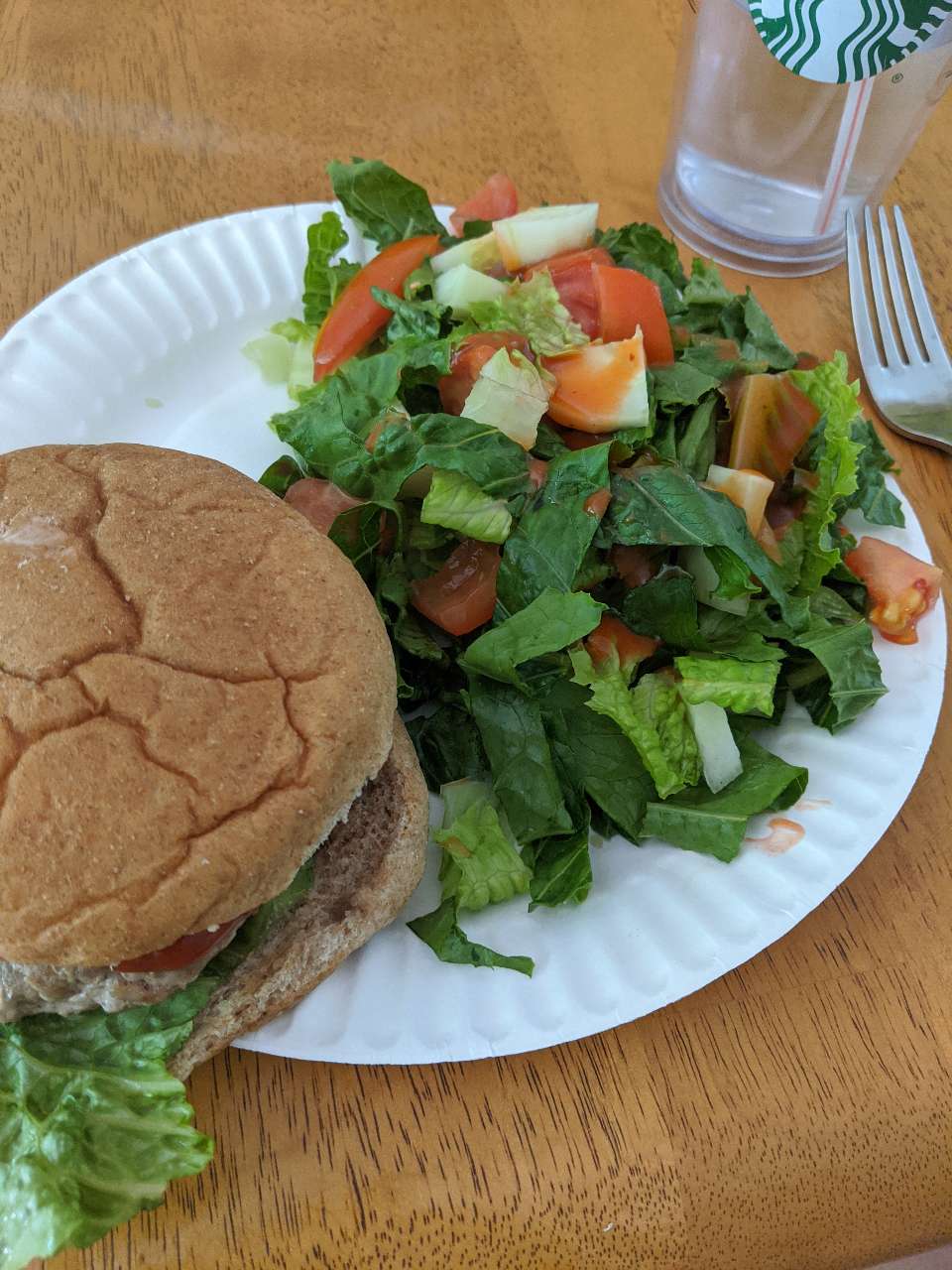 Turkey burger on a whole grain bun for lunch, with a side salad. I