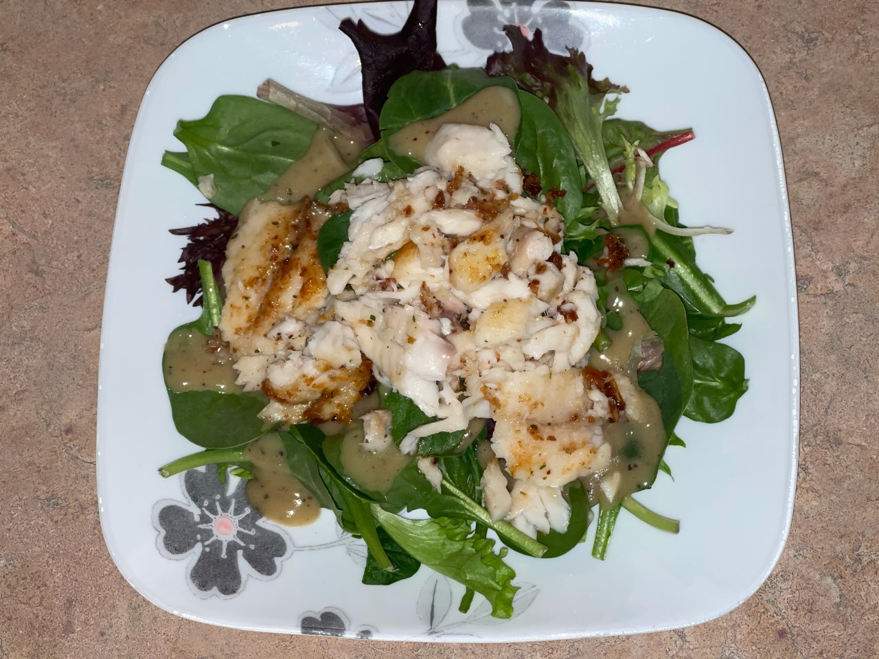 Pan seared Tilapia (shredded) on a bed of Baby Spring Mix, with light