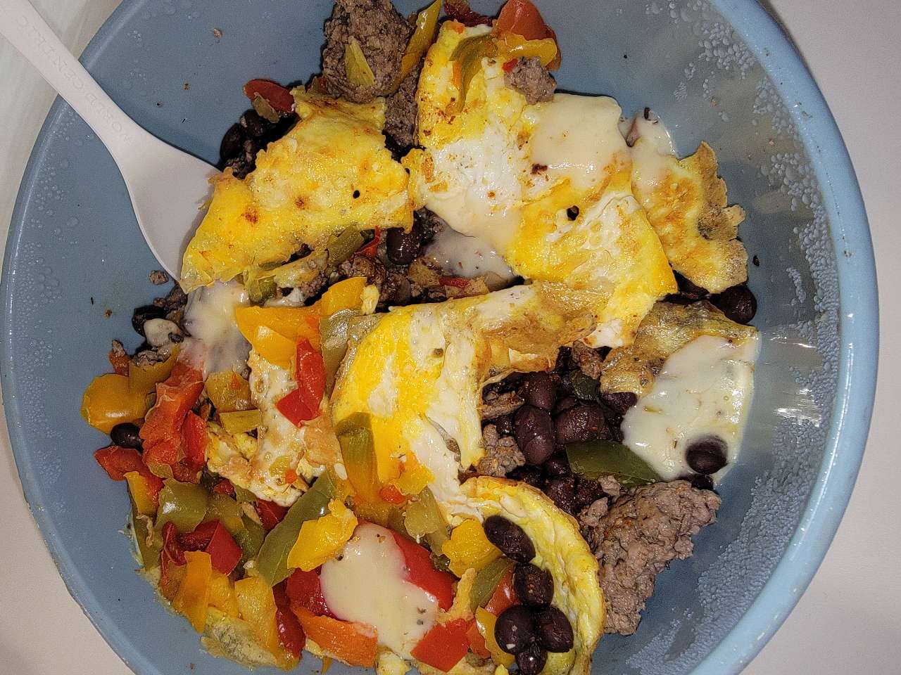 Ground beef, eggs, bell peppers, onions, black beans, peppered Jack