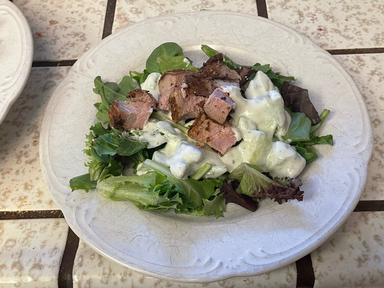 Pork w/gyro seasoning, tzatziki using Skyr nonfat yogurt , on a bed